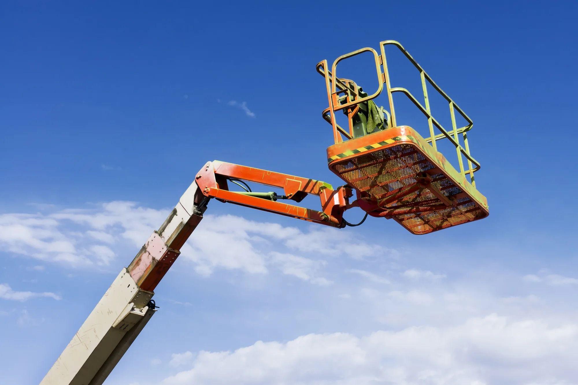 Boom lift clearing lights on Ohio barn at sunrise