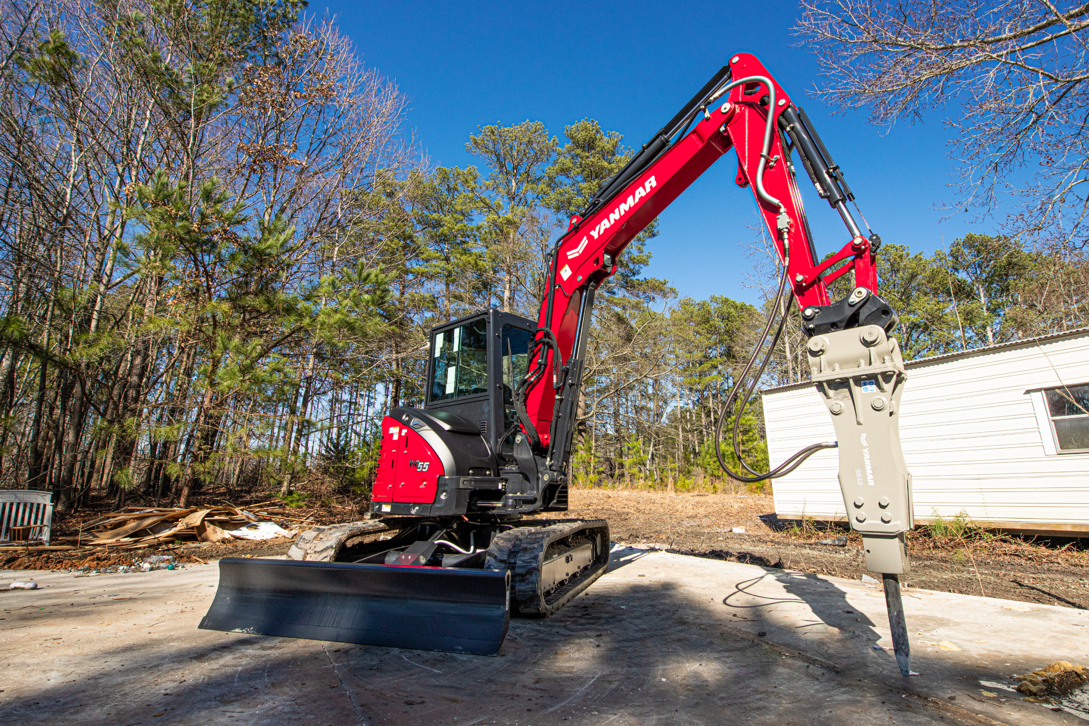 Ohio excavator rental delivered and unloading near jobsite