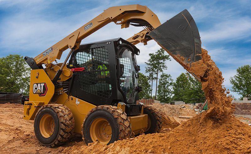 Contractor guiding skid steer rental delivery in Ohio
