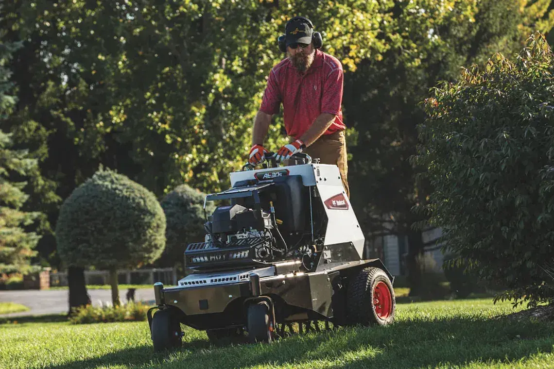 Professional landscaper using aerator on rental lawn in Ohio